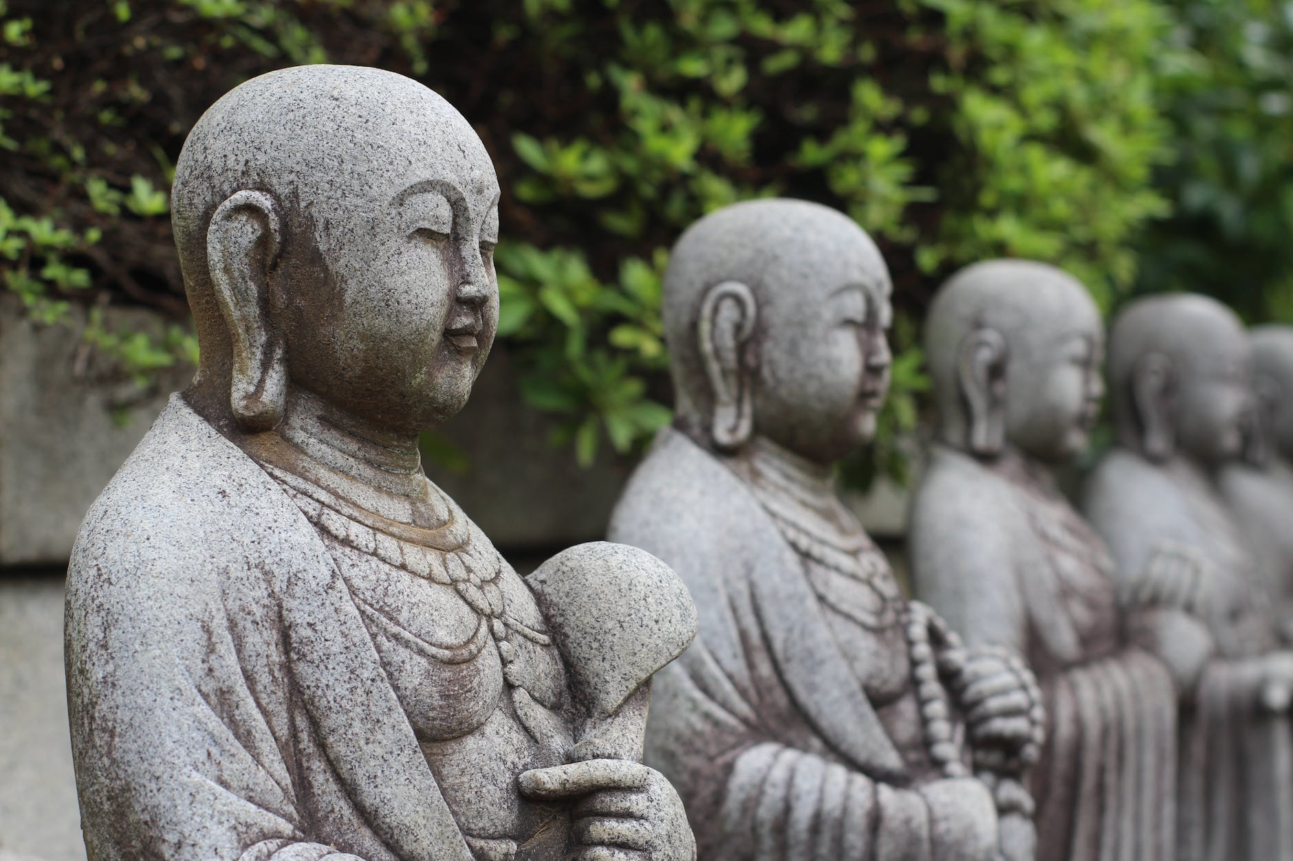 statues of little monks in close up photography